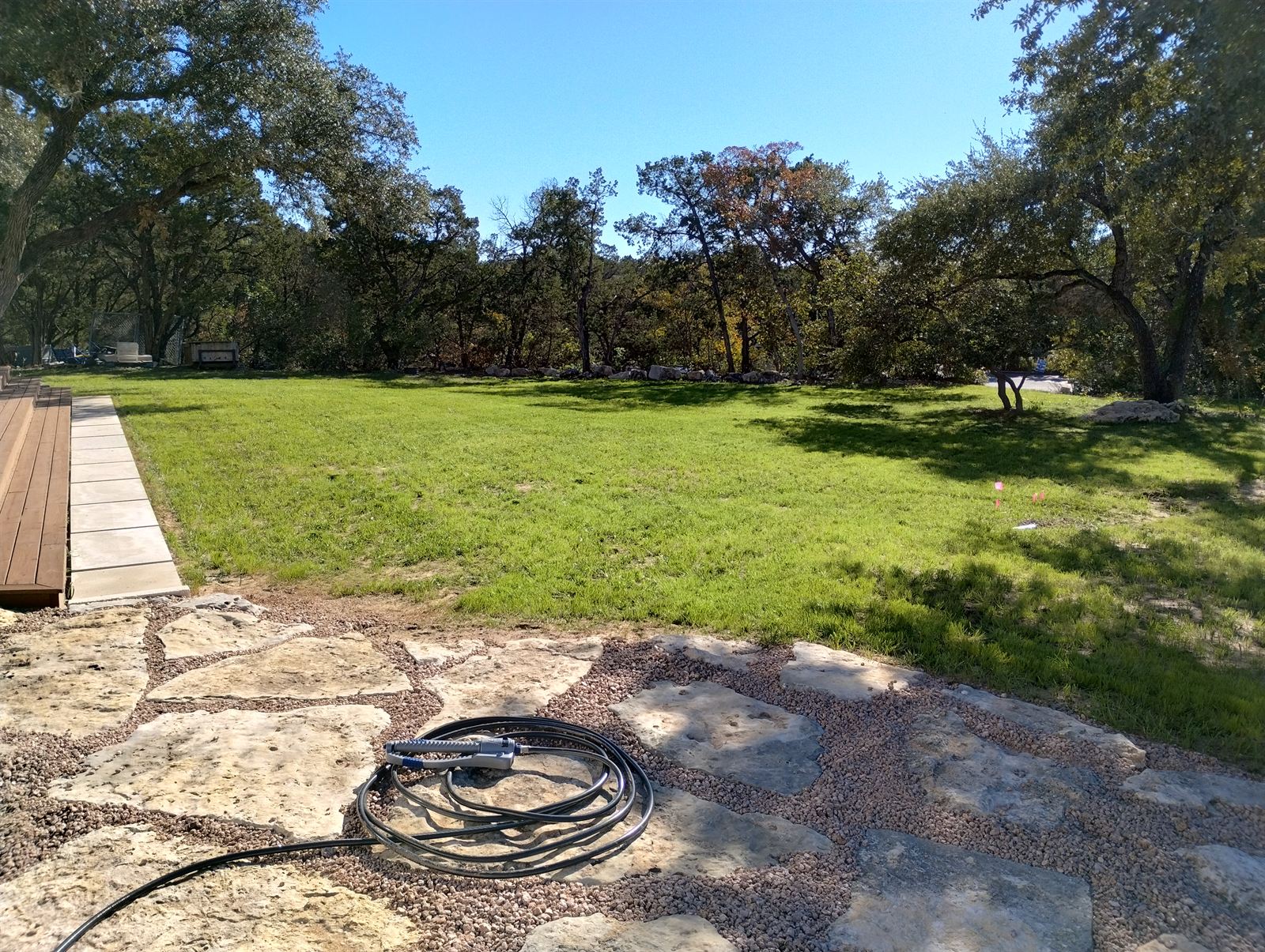 Maintained ranch grounds with new lawn and stone terracing